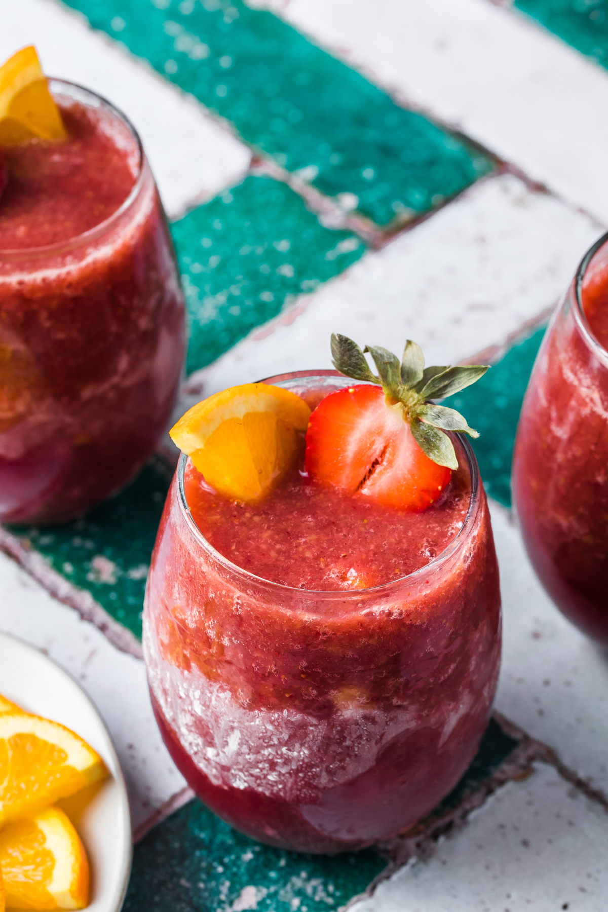 frozen sangria wine slushie in a frosted wine glass