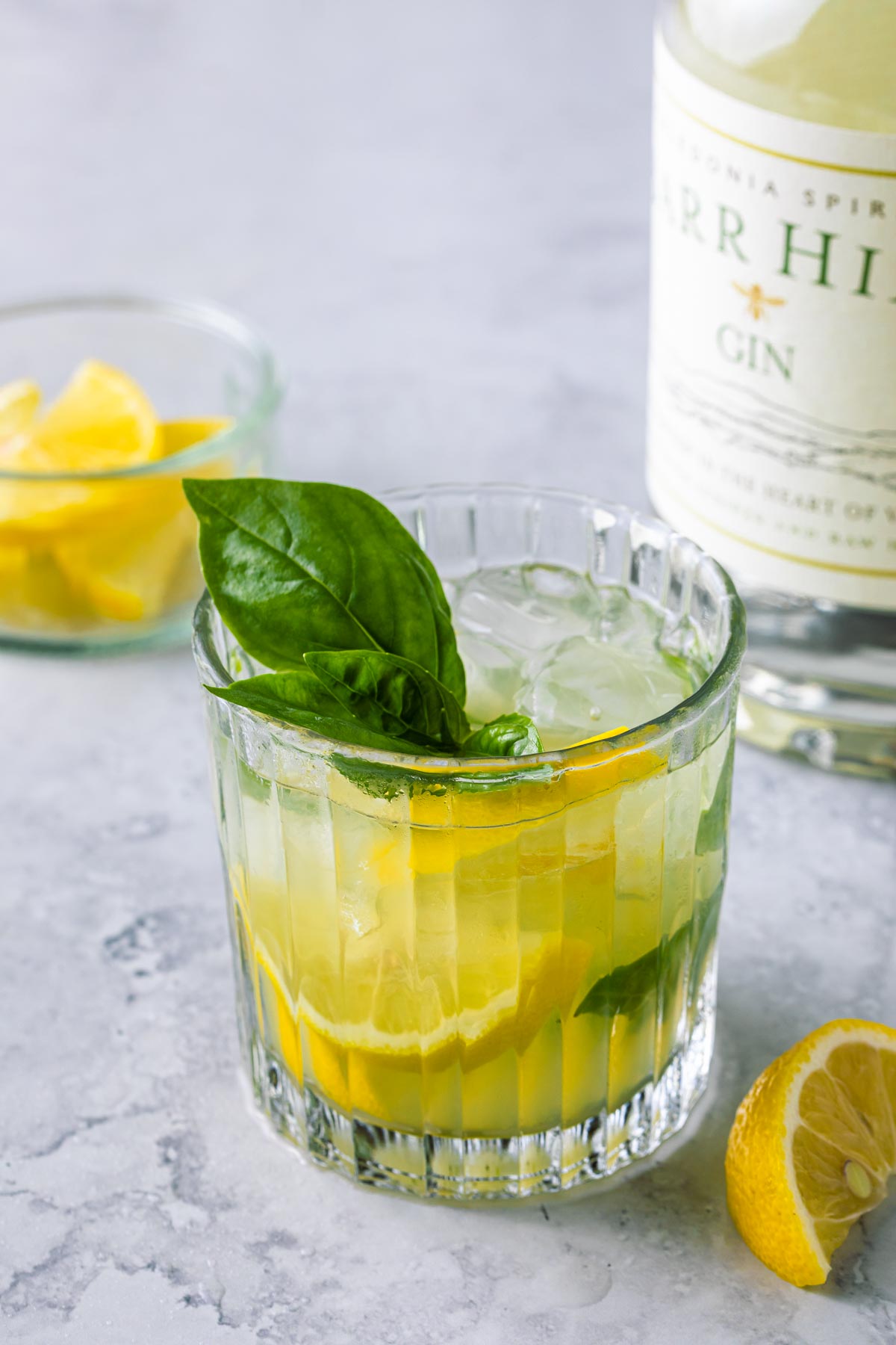 gin cocktail with lemon and basil