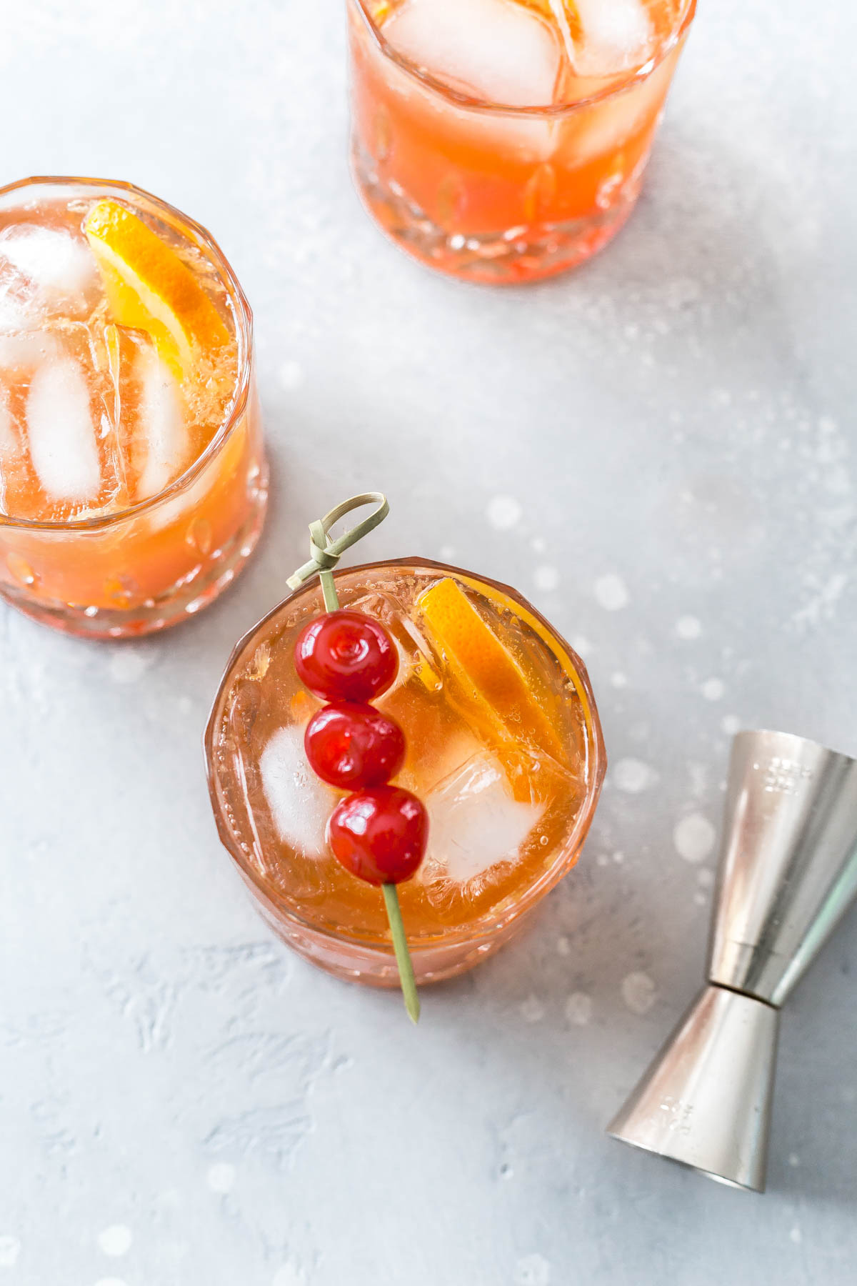 overhead of a brandy old fashioned garnished with cherries