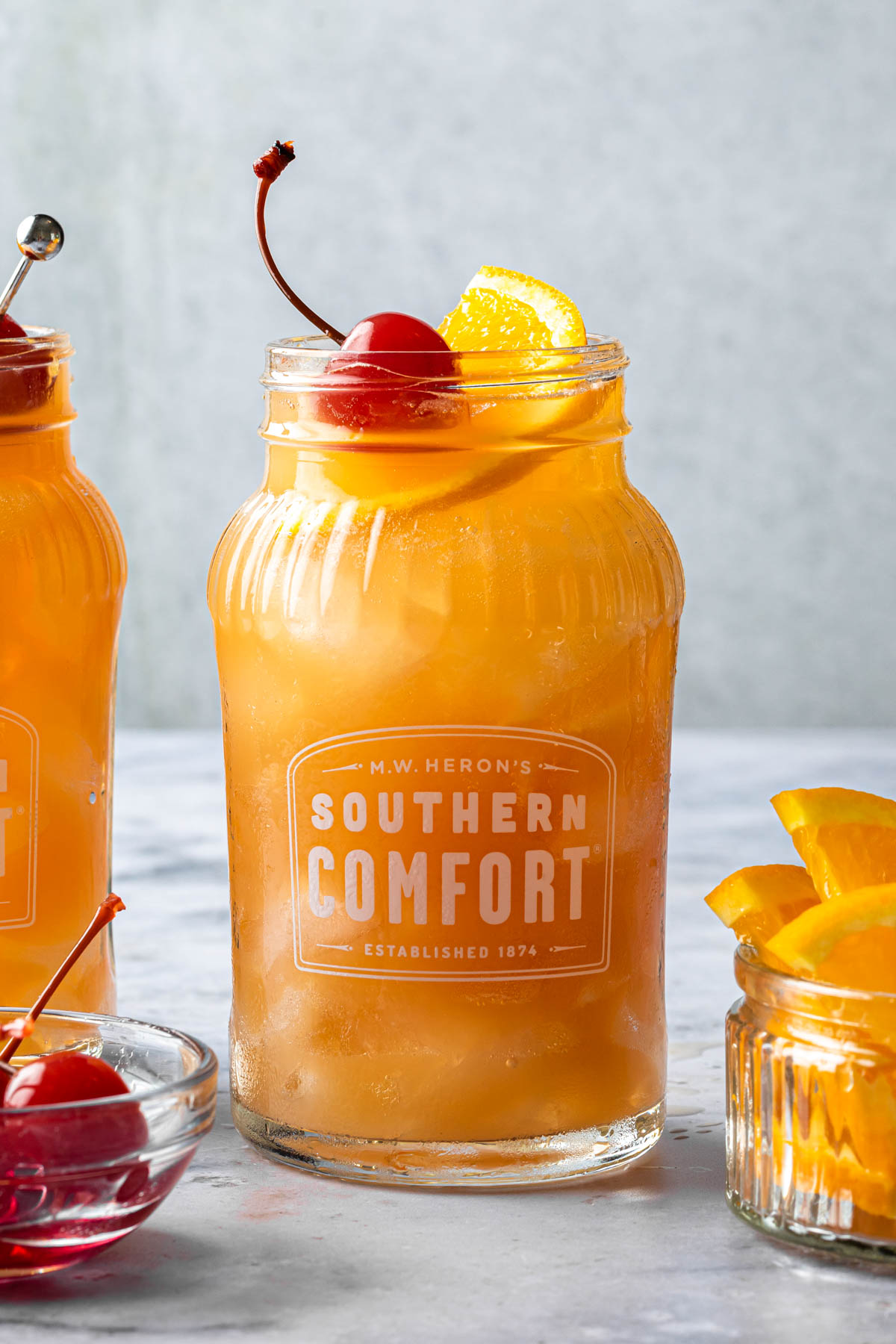 A close up of a southern comfort punch in a mason jar glass. 