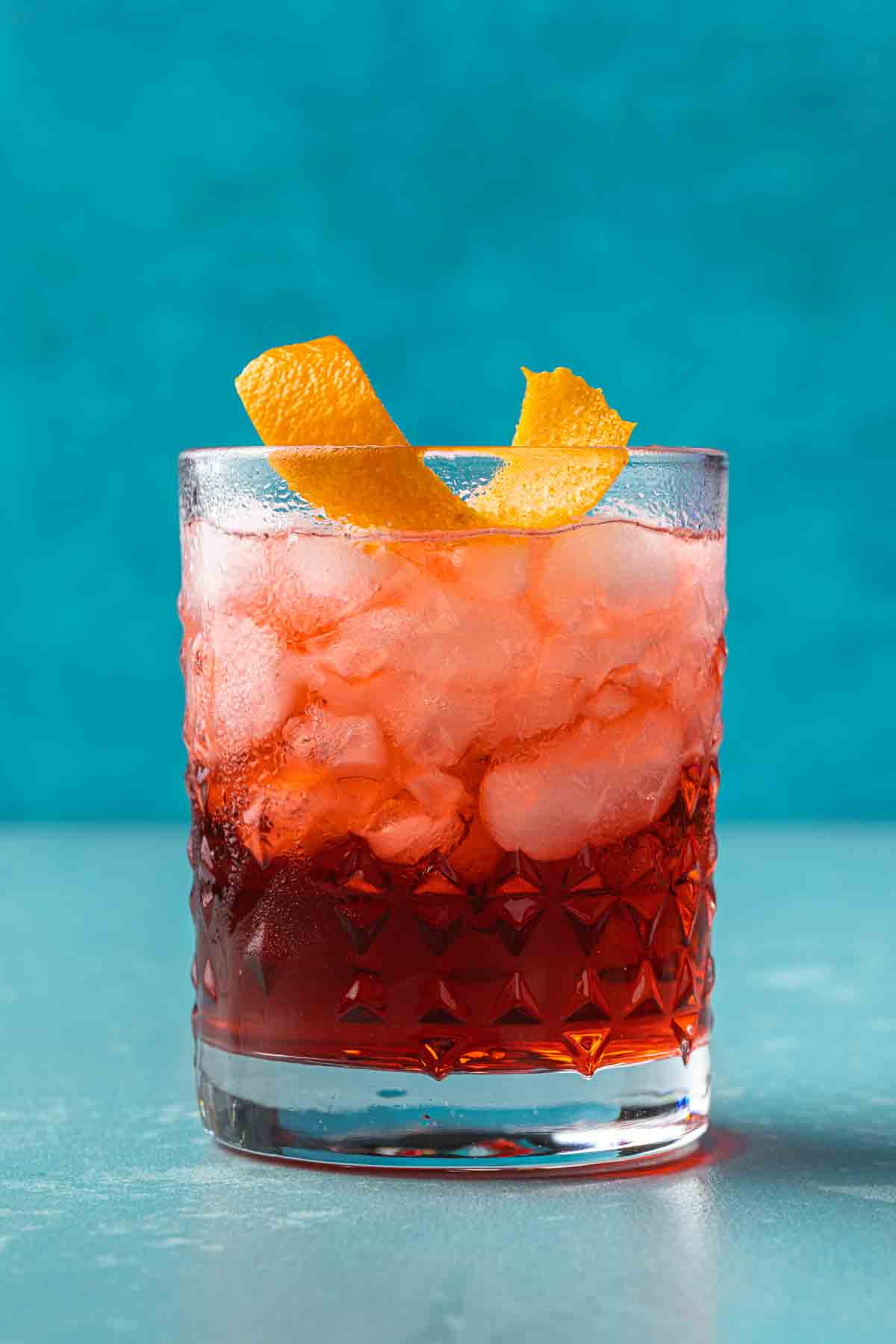 A mezcal negroni topped with an orange twist. 