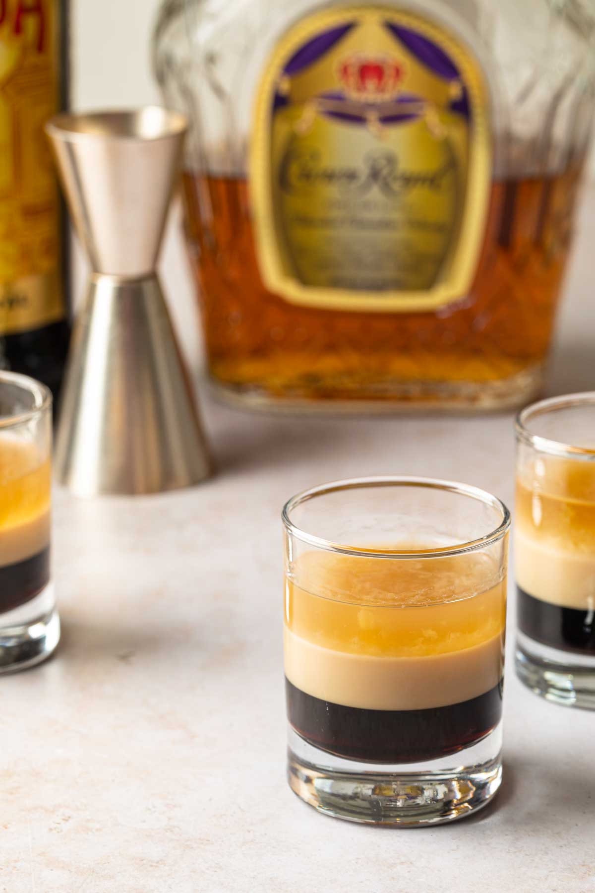 Duck fart shots with the bottles of crown royal, baileys, and kahlua in the background. 