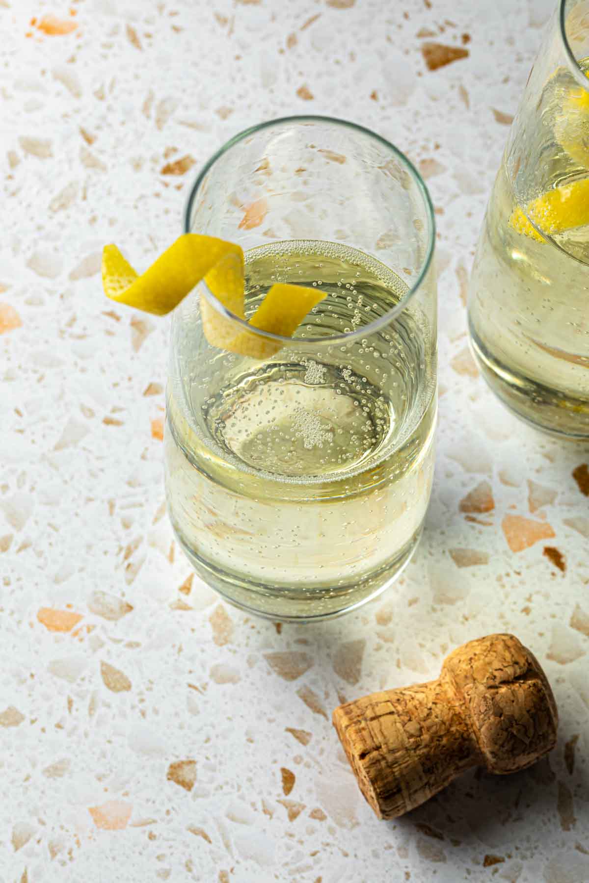 Champagne cocktails garnished with lemon twists. 