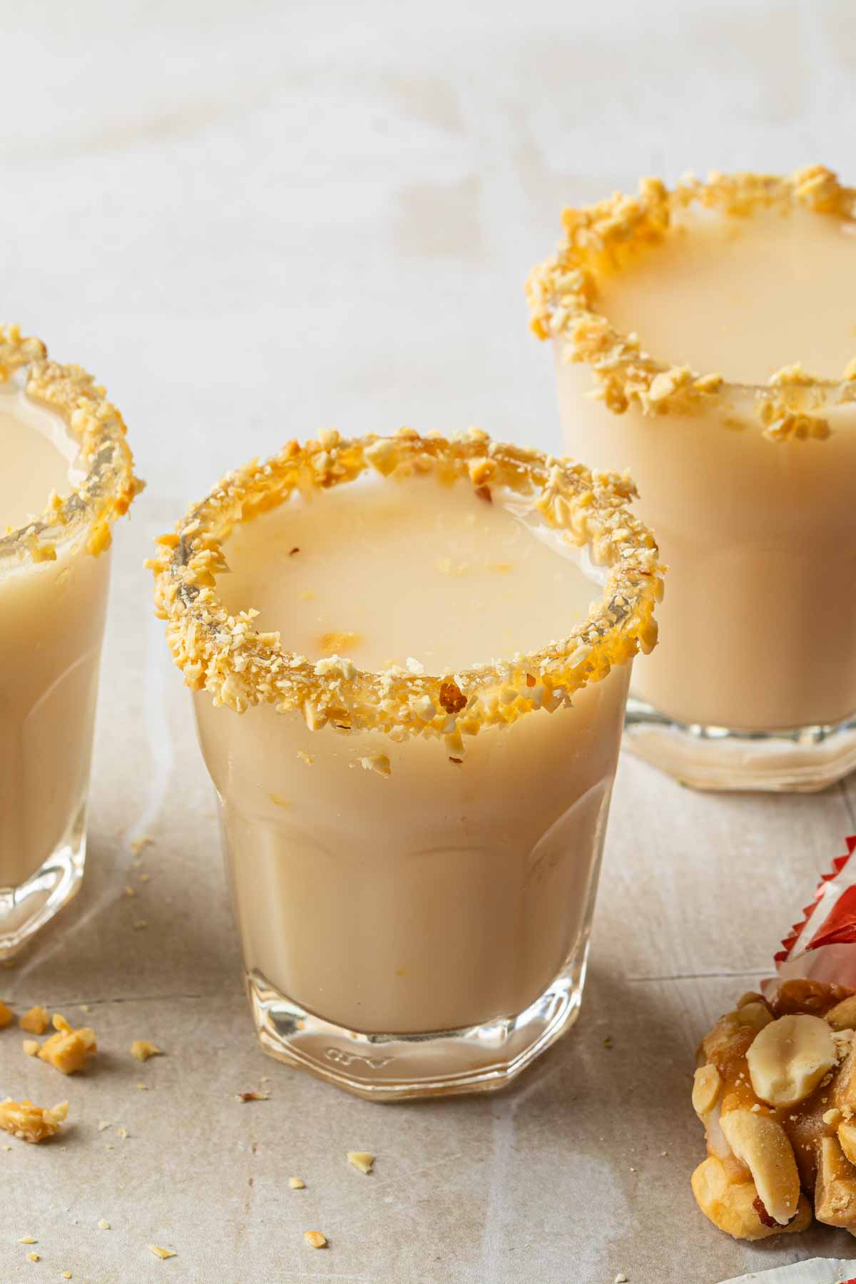 Shot glasses rimmed with crushed peanuts. 
