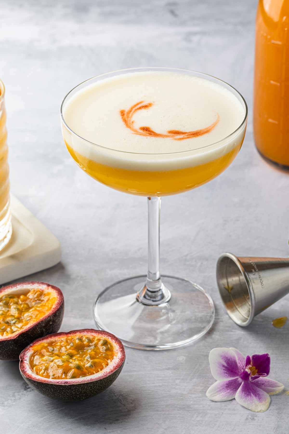A pisco sour made with passion fruit syrup, garnished with a swirl in the foam. 