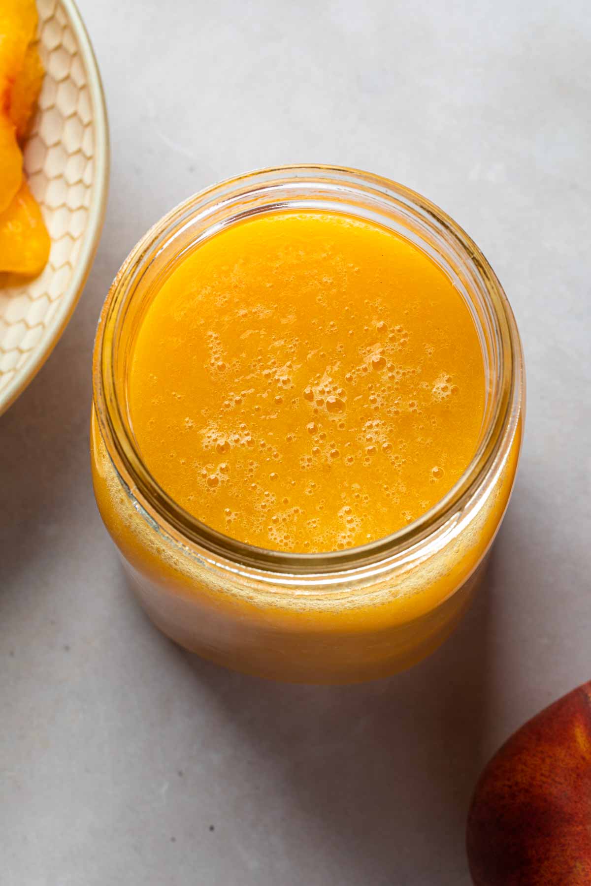 Close up of a fruit puree in a mason jar, made of peaches. 