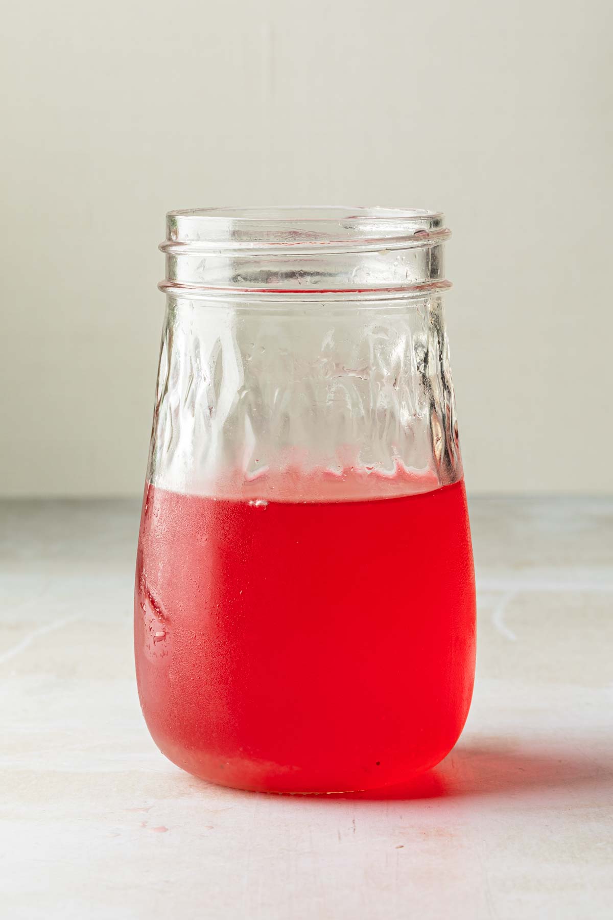 A mason jar of rhubarb simple syrup. 