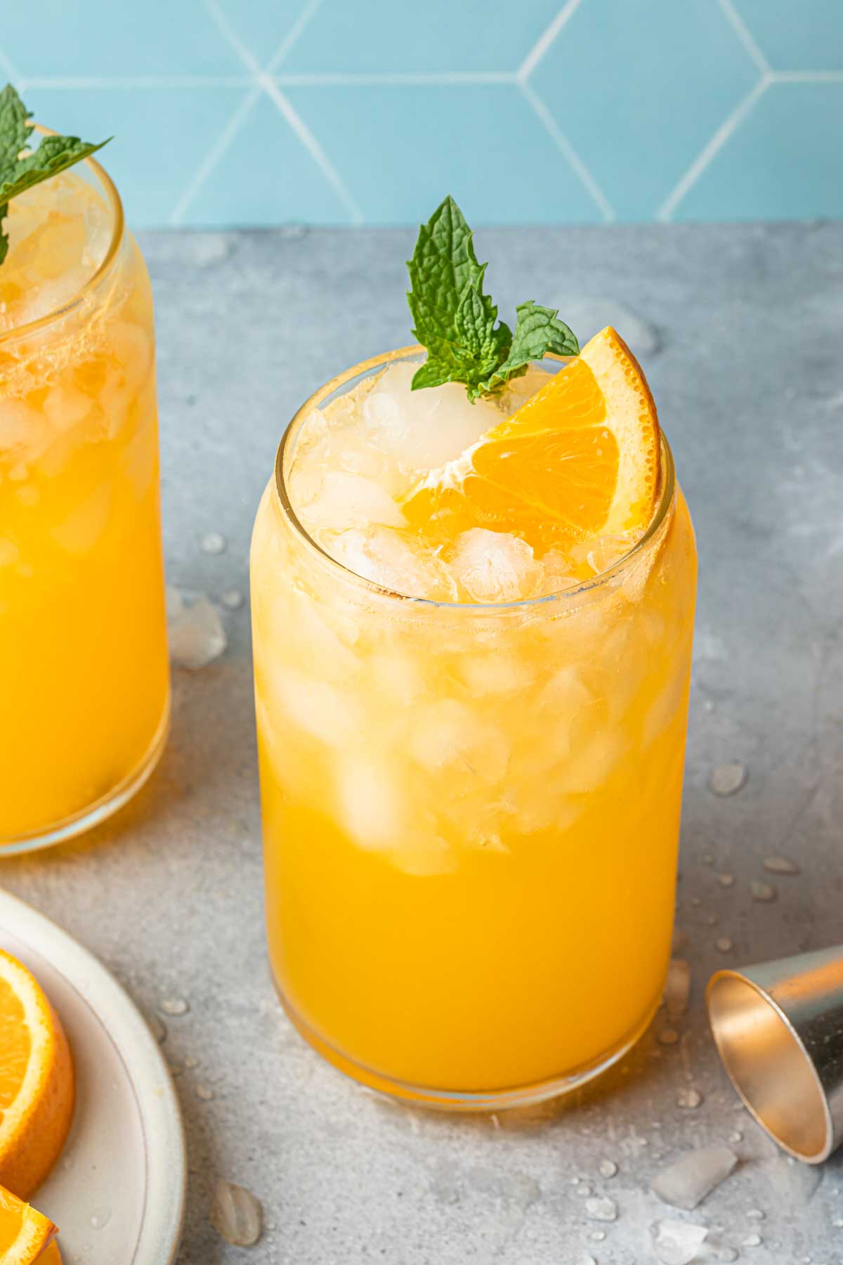 Orange crush cocktails in can glasses. 